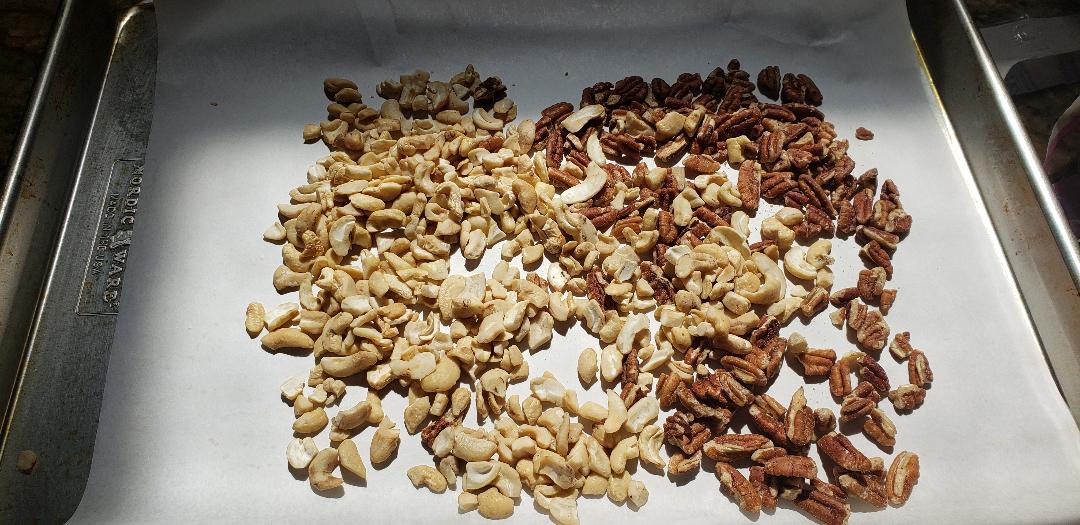 Toasting pecans and cashews on trays